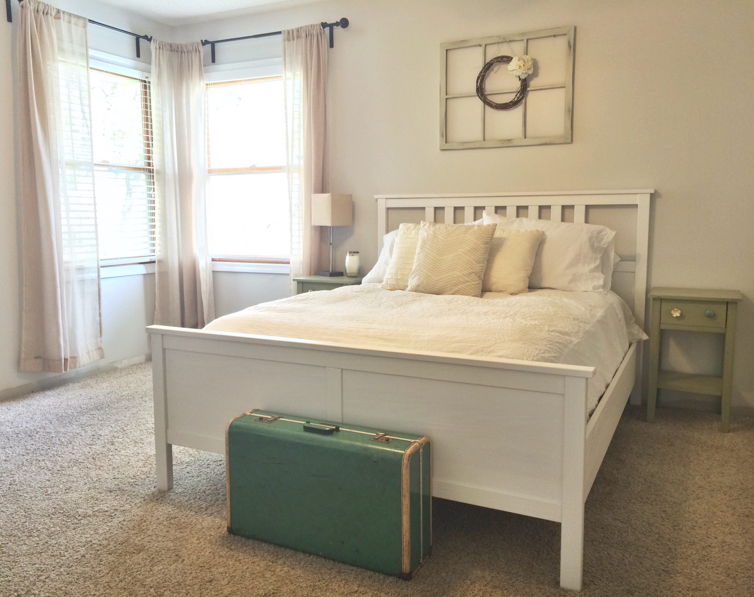 Neutral guest room, white Ikea bed, Behr Silver Drop walls, vintage suitcase, vintage window with wreath