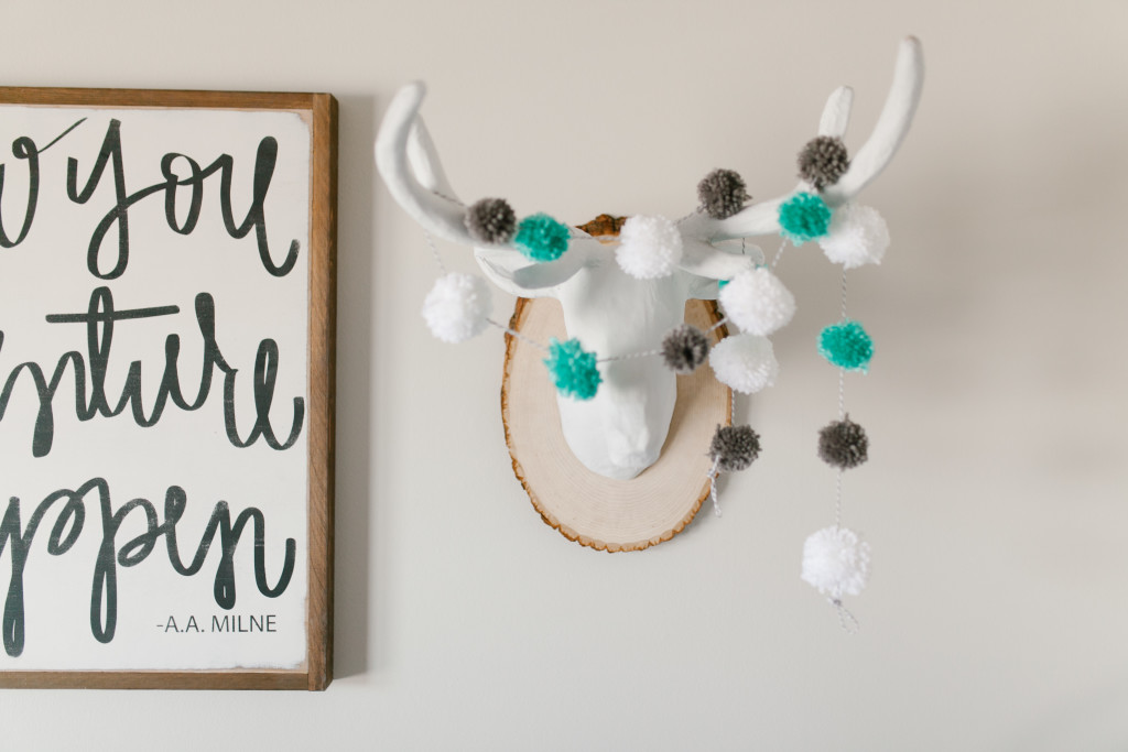 Caleb's Rustic Neutral Nursery Reveal With White, Gray, and Wood Accents Faux Deer Heads With Pom Pom Garland Closeup